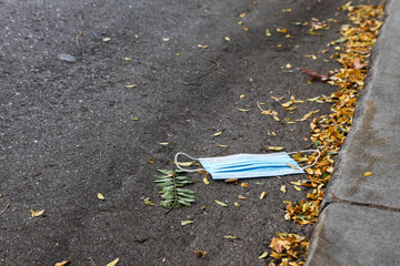 Blue protective mask on street in COVID-19 pandemic