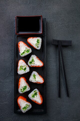 Seafood delicatessen salmon sushi rolls on plate