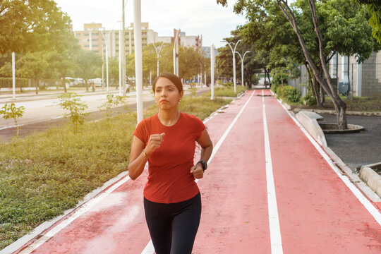 Latino Sports Woman Running In The Park. Healthy Fitness Lifestyle