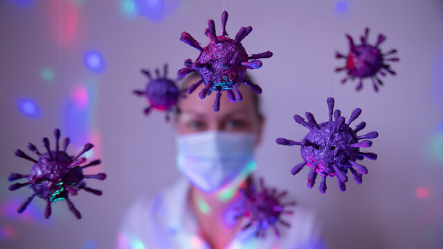 Fototapeta  Representation of the coronavirus, covid 19, and masked woman