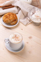 a white ceramic cup of cappucino as a coffee break concept