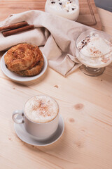 a white ceramic cup of cappucino as a coffee break concept