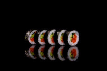 Fresh delicious beautiful sushi rolls on a dark background