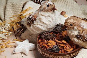 christmas decoration in rustic style and holiday background, still life on wooden backdrop, a stuffed bird and other