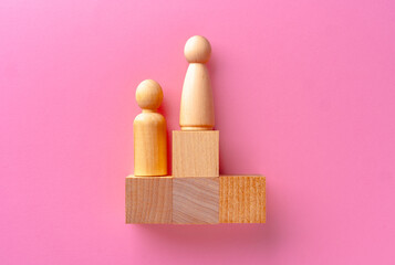 Top view of toy wooden blocks on pink