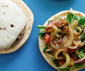 Bacon and cheese burgers on blue background