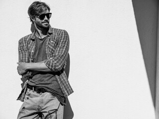 Portrait of handsome confident stylish hipster lambersexual model.Man dressed in T-shirt. Fashion...
