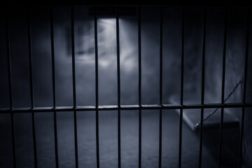 Jail or prison cell. Old grunge prison miniature. Dark prison interior creative decoration. Empty cell. Selective focus Obsolete gray grunge concrete room.