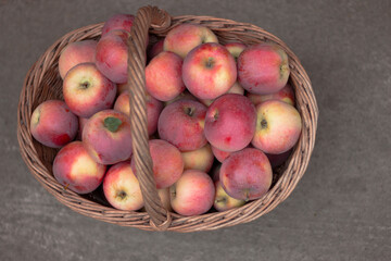 Fresh ripe red apples in a wicker basket. Autumn harvest