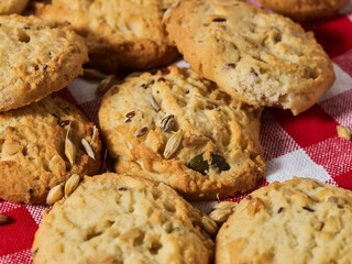 Oatmeal cookies is on gingham checkered fabric on table in rustic style. Healthy food breakfast.