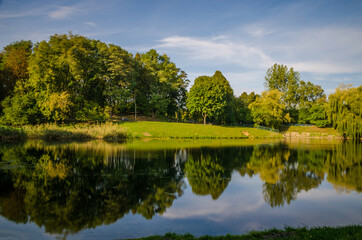 Fototapeta premium City park in the warm and sunny day during the autumn season. Landscape fulfilled of sunlight