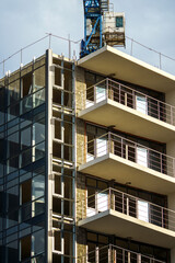 Construction site with crane and building with windows