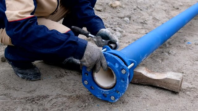 Workers installing water supply pipeline system, close up