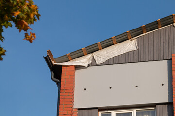 Fototapeta na wymiar Roof restoration works. Roof repair concept