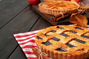 Close up of homemade traditional sweet autumn raspberry tart pie on wooden table