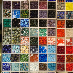 Top view to many colorful beads stores in small boxes.  Amazing hobby to beadwork at home.