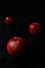 Fototapeta na wymiar Red apple isolated on the black wooden background