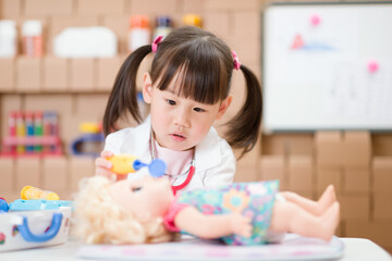 young girl pretend play doctor role  at home