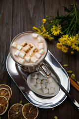Hot chocolate with marshmallows on a wooden table
