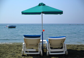 Empty beach chairs and umbrella on the beach