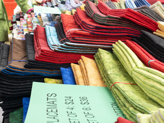 colorful fabrics on a table at an outdoor farmers market