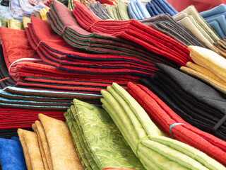 colorful fabrics on a table at an outdoor farmers market