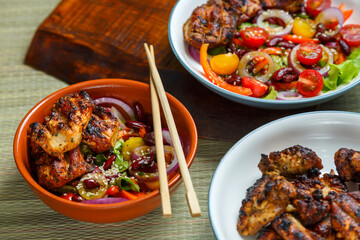 Plates of Pan-Asian sesame salad and grilled chicken pieces in yakitori sauce.