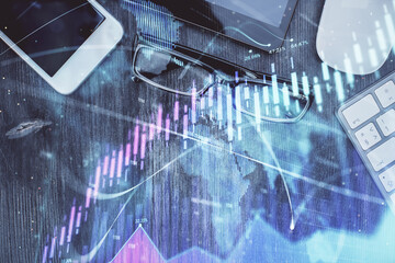 Multi exposure of forex graph hologram over desktop with phone. Top view. Mobile trade platform...