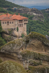 Fototapeta na wymiar View of Varlaam Monastery. Beautiful scenic panoramic view, ancient traditional greek building on the top of huge stone pillar in Meteora,Thessaly, Greece, Europe on a cloudy day.