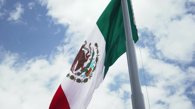 Mexican Flag Waving in the Wind and a Cloudy Sky as the Background