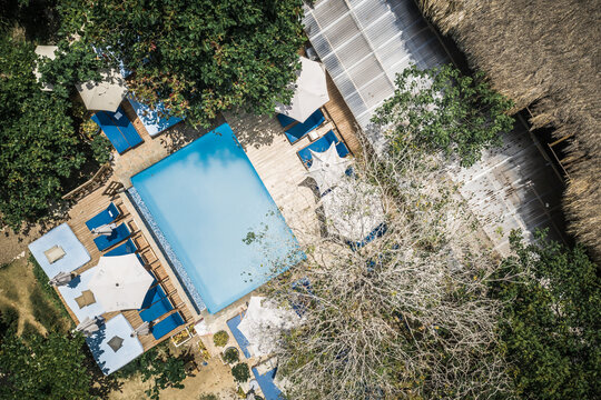 Aerial View Of People Swimming In Pool At Luxury Tropical Island Resort Surrounded By Lush Trees, Tierra Bomba, Colombia