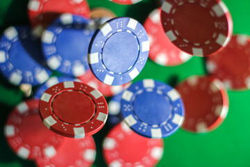 Poker chips falling with green background