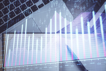 Stock market graph and top view computer on the table background. Multi exposure. Concept of financial education.
