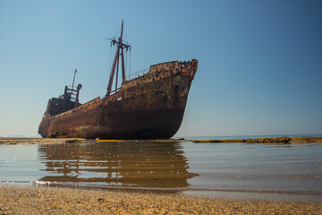Dimitrios shipwreck in  Gythio, Greece. A partially sunken rusty and metal shipwreck decaying...
