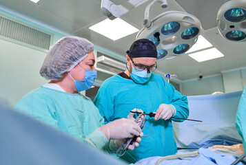 surgeon in the operating room performs the operation