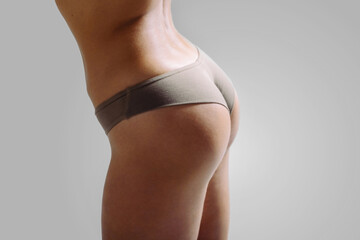 Beautiful girls buttocks in underwear. Close up photo of woman's panties. Not a perfect female body