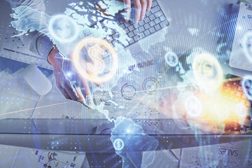 Multi exposure of man's hands typing over computer keyboard and forex graph hologram drawing. Top view. Financial markets concept.