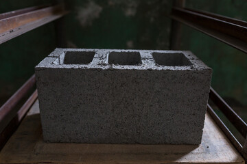 Industrial production of building materials from pressed cement mortar. High quality hollow concrete block or cement brick. Finished products stacked on pallets dry after the press.