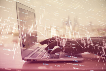 Double exposure of woman hands typing on computer and forex chart hologram drawing. Stock market invest concept.