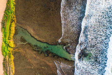 Aerial view of rocks and pool formation close to Praia do Forte and Praia do Lord, Brazil.