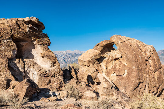 rock formations in desert valley with distant mountains extreme terrain in California