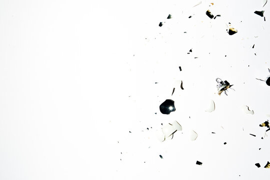 Broken pieces of a christmas balls are sprea around a clen background,top view.