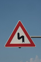 curve on the road and traffic sign