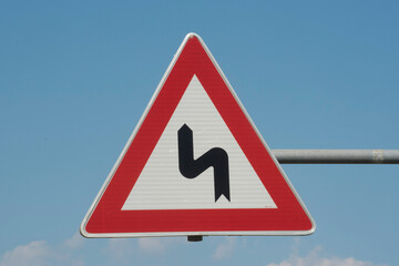 curve on the road and traffic sign