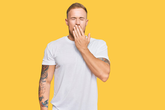 Young irish man wearing casual clothes bored yawning tired covering mouth with hand. restless and sleepiness.