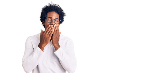 Handsome african american man with afro hair wearing casual clothes and glasses laughing and...