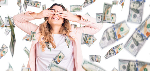 Young caucasian woman wearing business clothes covering eyes with hands smiling cheerful and funny....