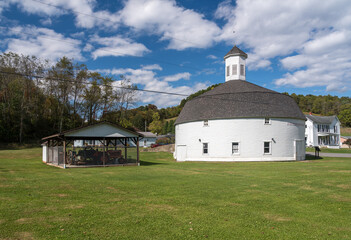 Fototapeta premium Well preserved white wooden round barn with cupola in Mannington, West Virginia