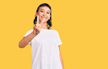 Young woman wearing casual clothes showing and pointing up with fingers number two while smiling confident and happy.