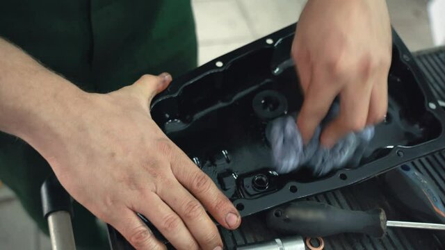 Removed automatic transmission CVT gearbox bottom cover for oil change in car service, close up.